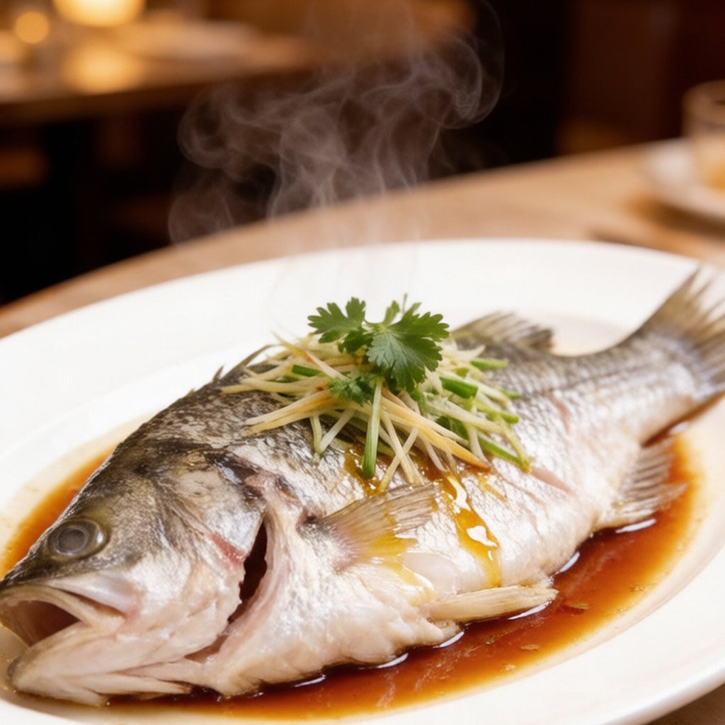 Steamed whole sea bass dressed with ginger, scallion and warm soy
