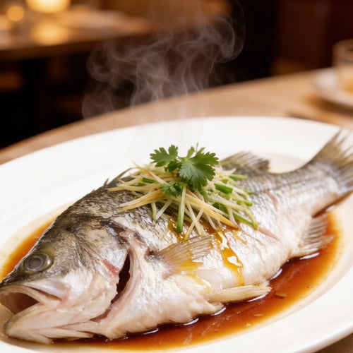Steamed whole sea bass dressed with ginger, scallion and warm soy