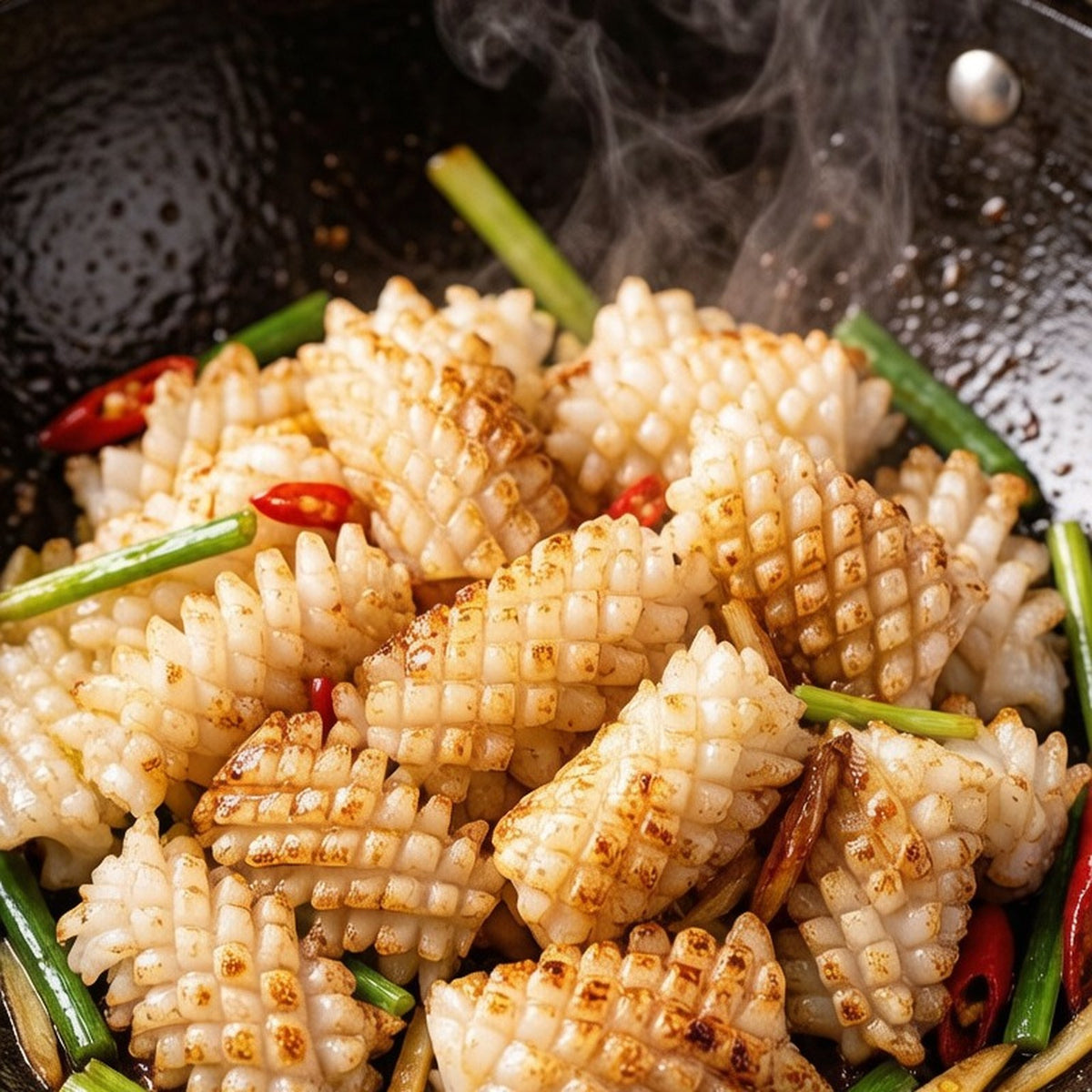 Squid flowers tossed in a wok with chili and scallion, edges lightly charred